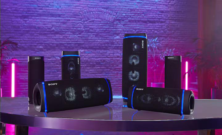 SRS-XB43 on table alongside multiple Bluetooth compatible models with party lights